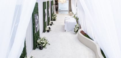 Elegant white wedding entrance with lush floral arrangements