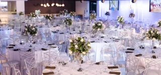 Elegant event venue setup with round tables for wedding.